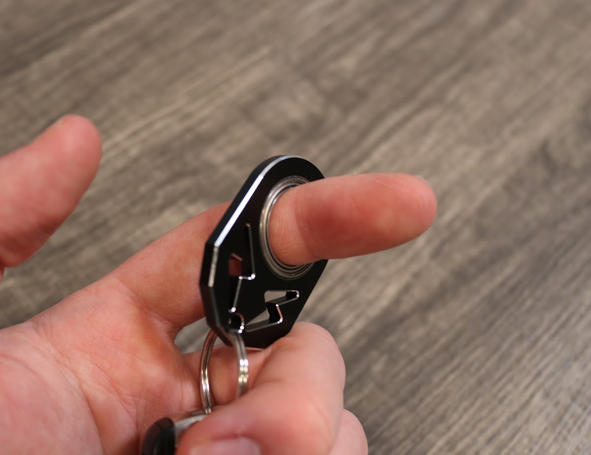 Person holding the KeyKaram key spinner between their fingers